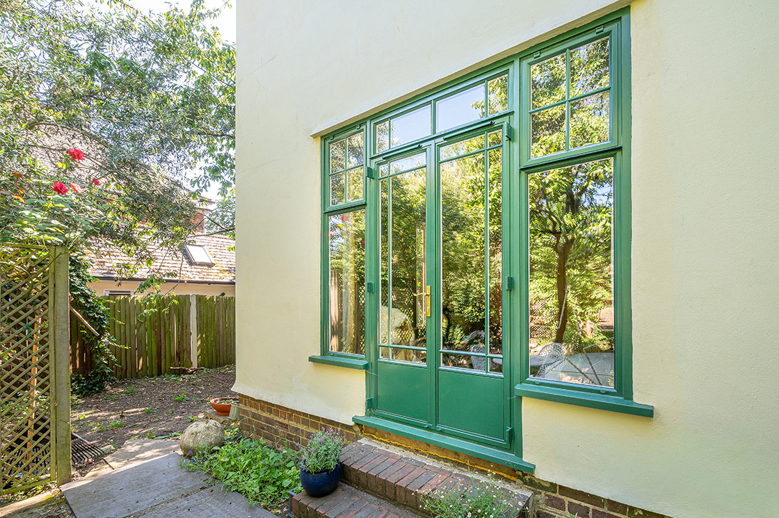 Bespoke green steel windows and doors for Art Deco style London home
