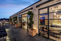 These elegant Clement doors made from slim EB24 steel sections provide the 'wow' factor for this rooftop bar