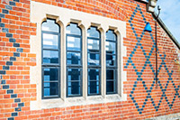 A combination of intricately shaped head windows manufactured by Clement for this historic school in Newbury.