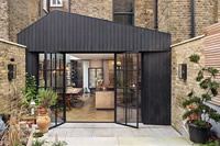 Daniel Harris Architects transformed this Victorian London home by adding a modern kitchen extension. Clement EB24 steel doors let natural light flow through the ground floor, as well as opening out onto the newly landscaped garden. Photography: GG Archard.