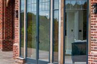 A Clement EB20 steel door surrounded by steel windows makes a fabulous feature in this Surrey home.