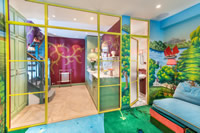 Hannah Cecil-Harden, director at de Gournay chose red and yellow steel door frames to divide the utility room and playroom at her London home.