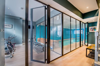 Designers are incorporating Clement steel screens into an array of projects. Here they have been used to partition a gymnasium and swimming pool in this beautiful London house.