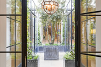 What a courtyard, the use of black steel screens creates a dramatic entrance.