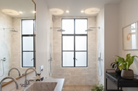 This double shower is lit up with the use of a super slim Clement steel window in this recently refurbished London property. Photography by Peter Landers.