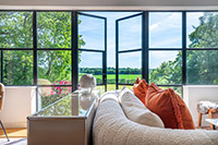 Slim framed black steel doors make quite the statement in this Kent home.