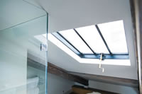 A Clement 4 rooflight creates the wow factor in this beautiful bathroom.