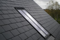 A completely flush Clement Conservation Rooflight in a slate roof.