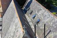 For Stapehill Abbey, several different sizes of Clement skylights were specified for the various roof types- here you see a row of rooflights in a slate roof.