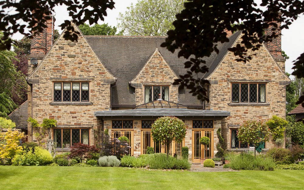 Stone fronted house with leaded metal windows