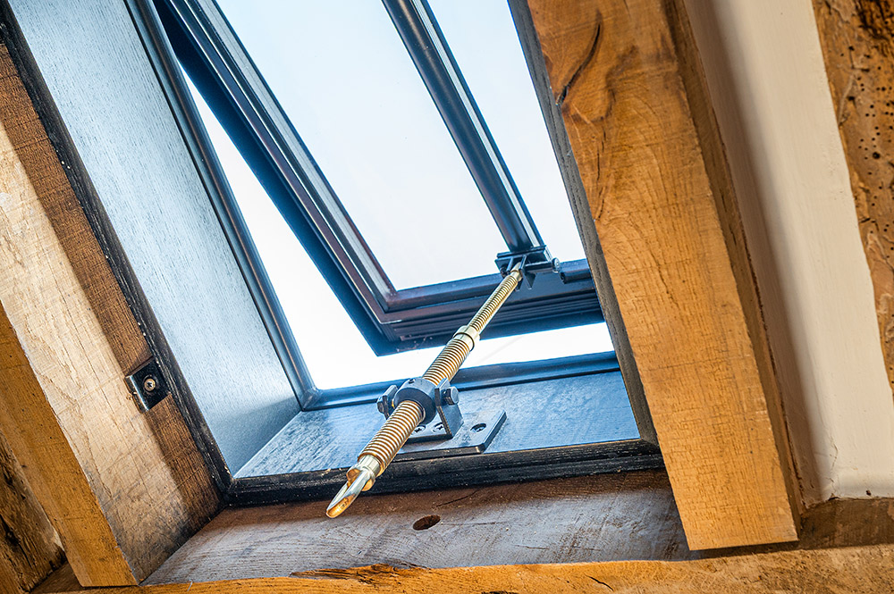 A tile profile Clement Conservation Rooflight with a brass pole winder.
