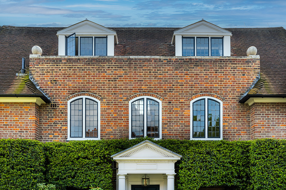 Three beautifully shaped steel windows with leaded lights